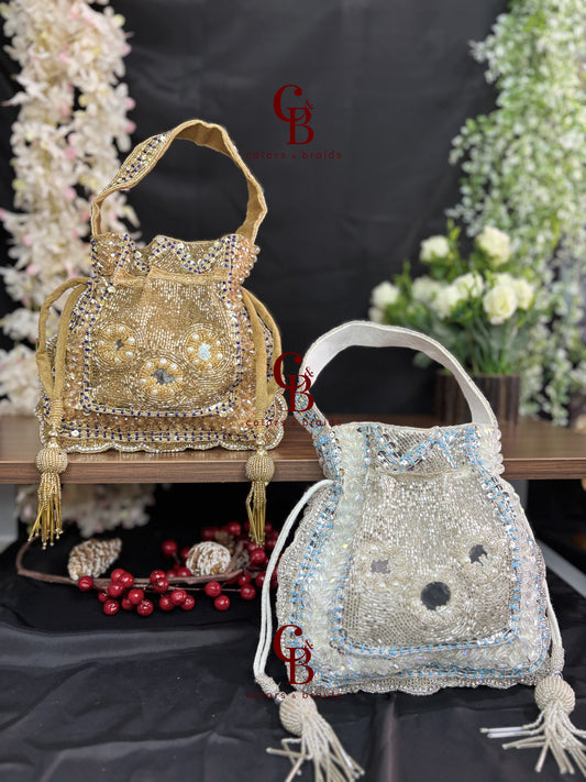 Handcrafted velvet potli bag featuring crystal, cutdana, mirror work, bead embellishments, and tassel drawstrings for weddings and festive occasions.