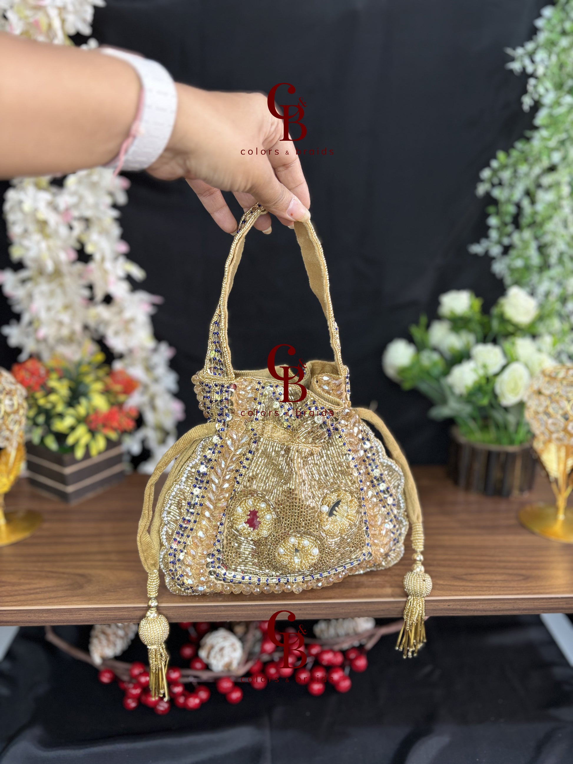 Handcrafted velvet potli bag featuring crystal, cutdana, mirror work, bead embellishments, and tassel drawstrings for weddings and festive occasions.