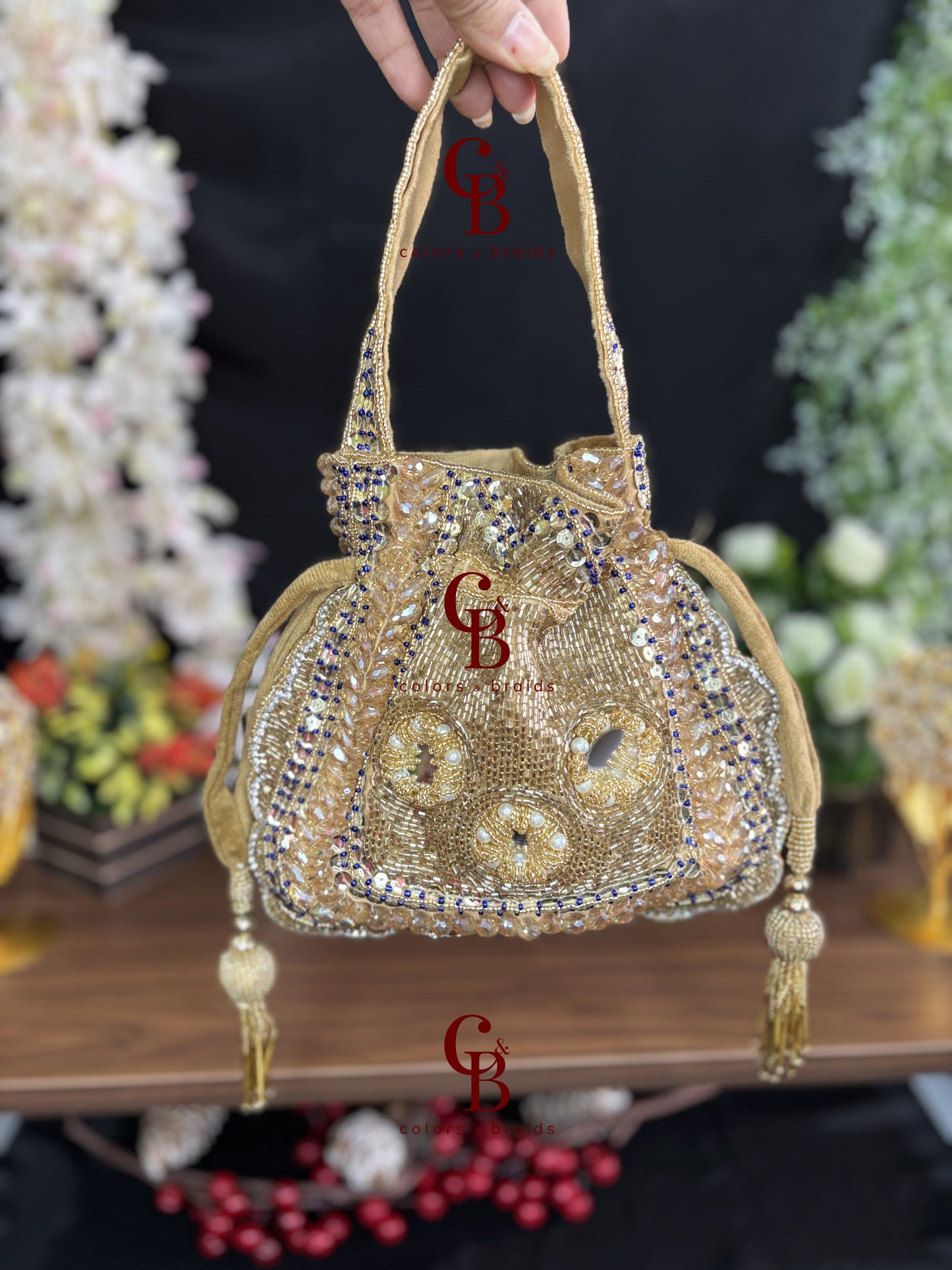 Handcrafted velvet potli bag featuring crystal, cutdana, mirror work, bead embellishments, and tassel drawstrings for weddings and festive occasions.