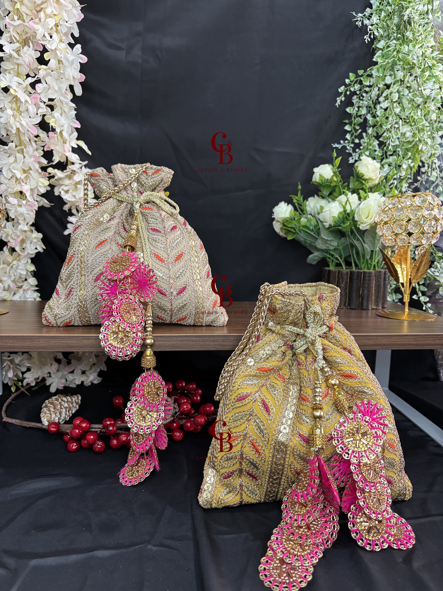 Handcrafted embroidered potli bag with statement tassels and metal chain