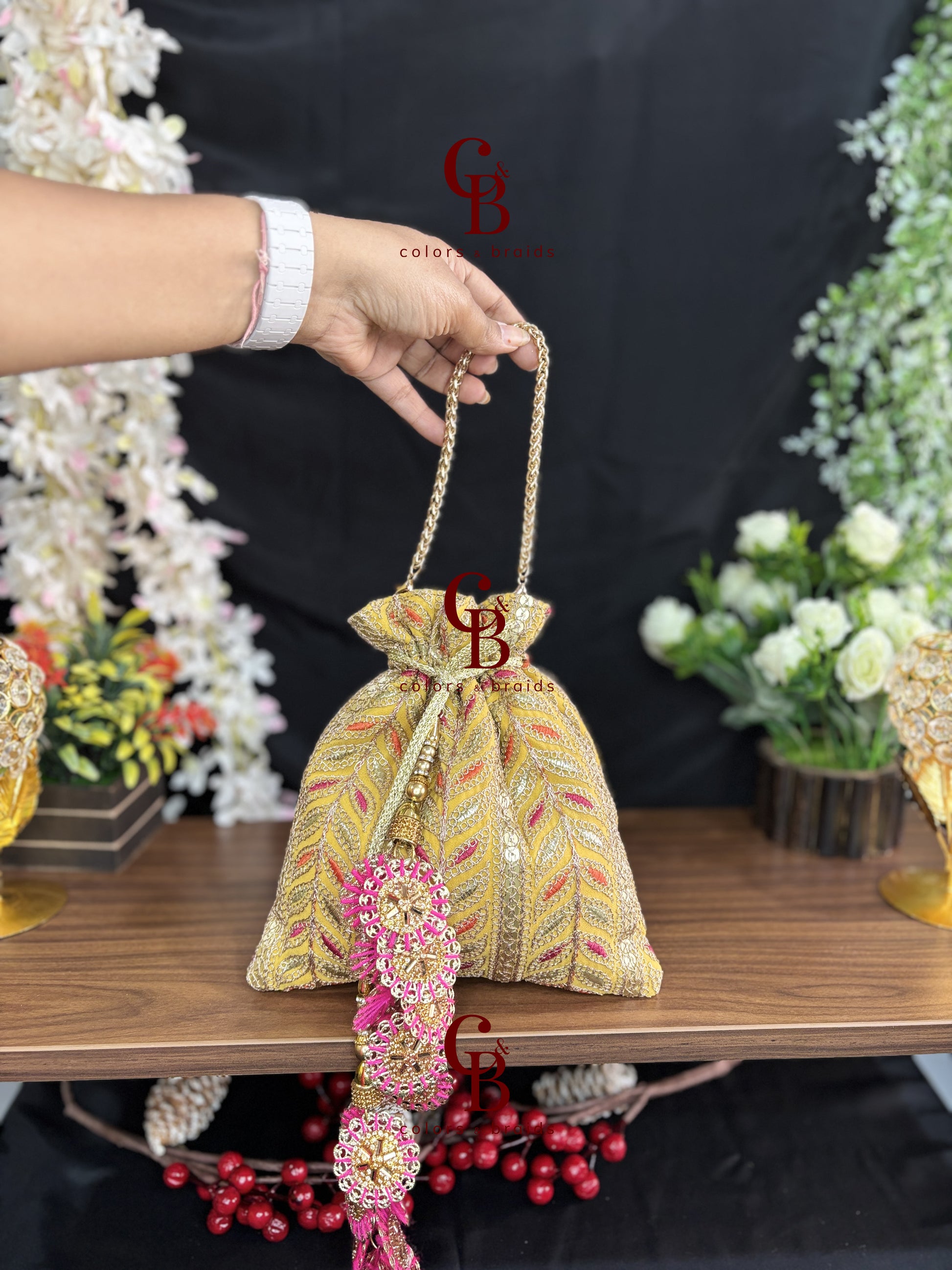 Gold embroidered festive potli with handcrafted tassels and chain handle