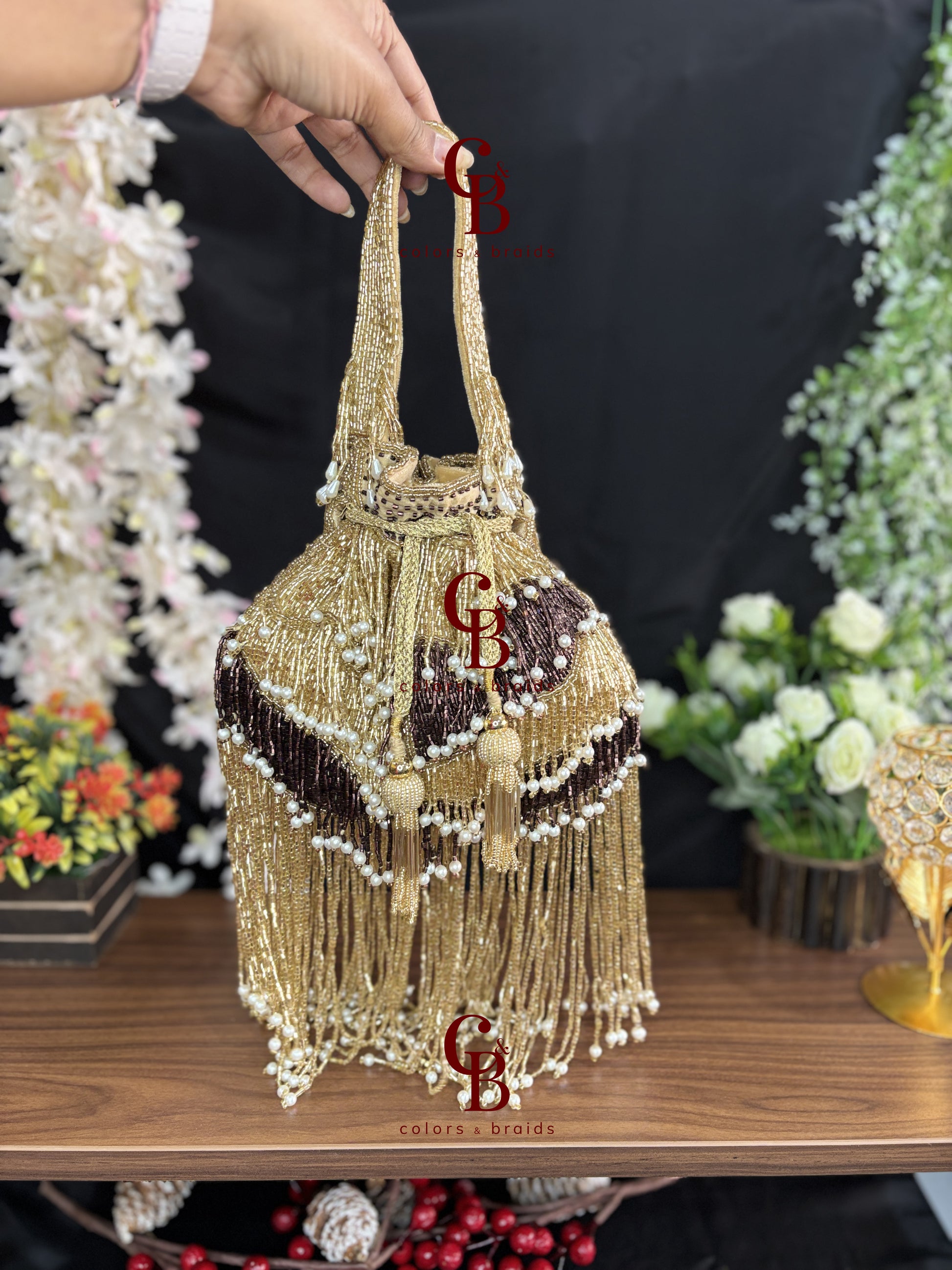 Gold handcrafted fringe potli with pearl accents and tassels