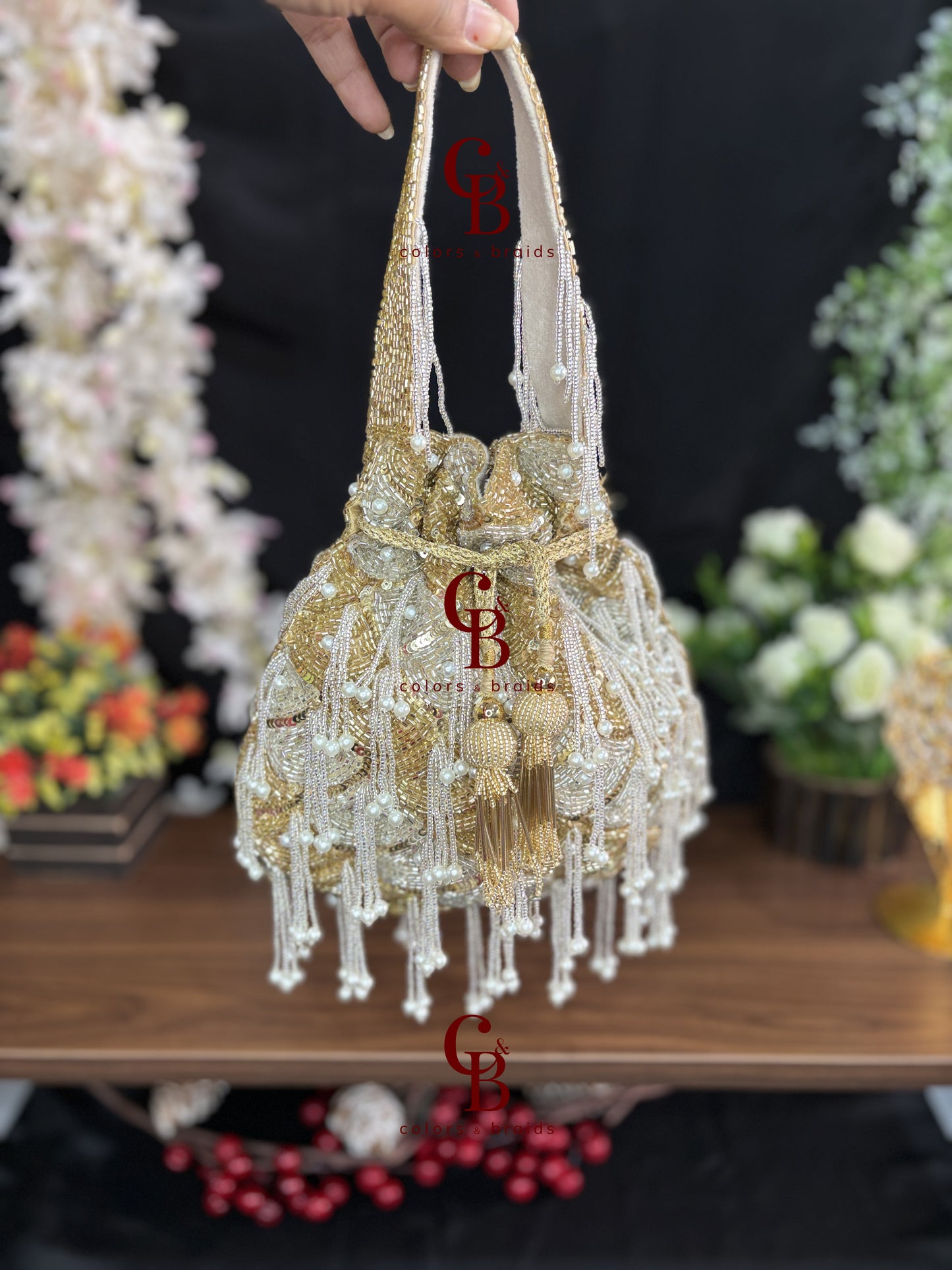 Handcrafted gold and ivory fringe potli with pearl tassels and bead embroidery